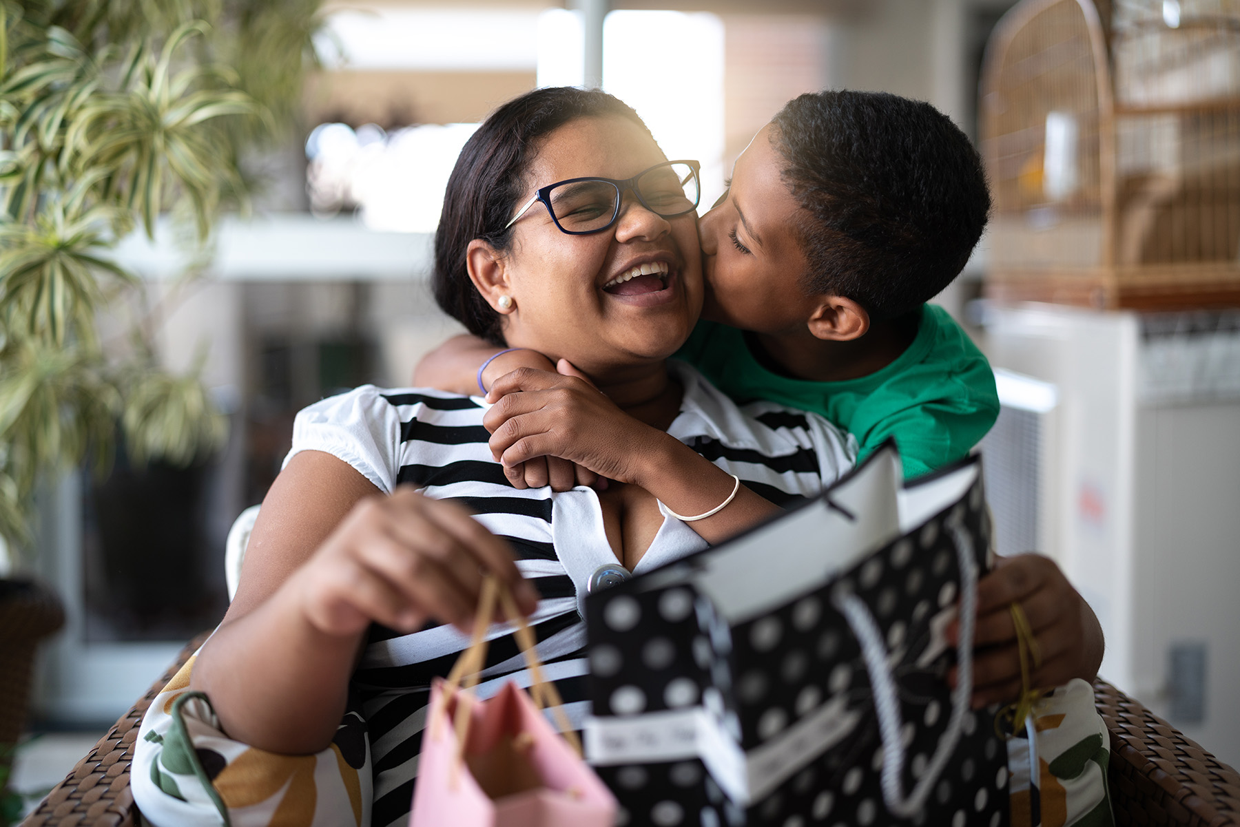 Mother and son embracing and receiving gifts