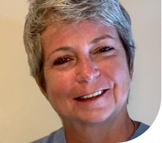 Close up of woman with gray hair smiling at camera