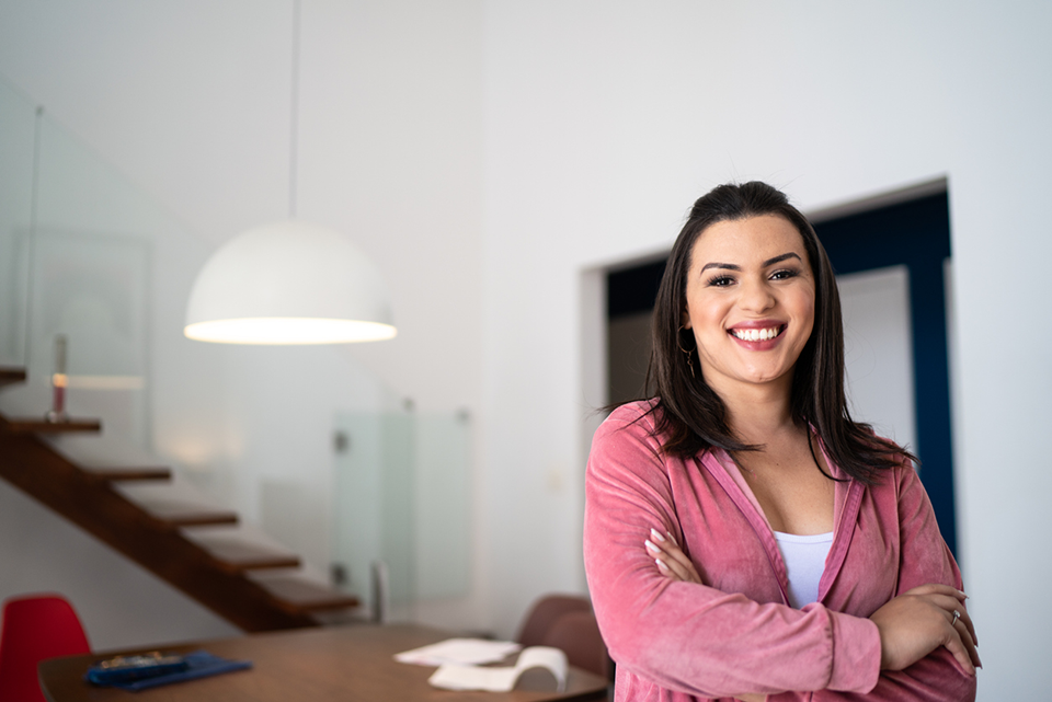 Woman in pink top standing at wooden table